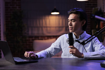 Young woman using laptop at table