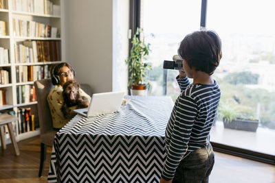 Friends sitting on table at home