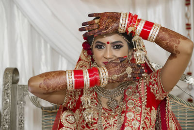 Portrait of bride gesturing over face