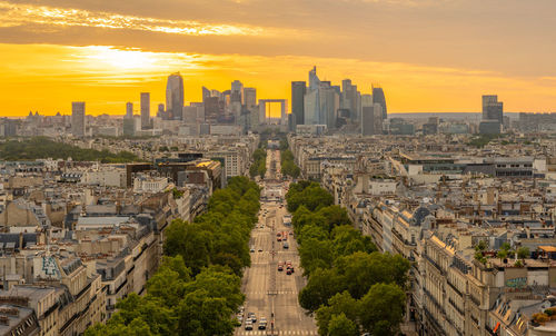 High angle view of buildings in city during sunset