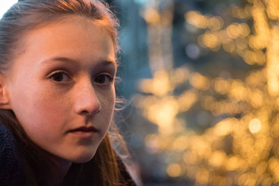 Close-up portrait of young woman in city