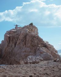 Low angle view of rock formations against sky