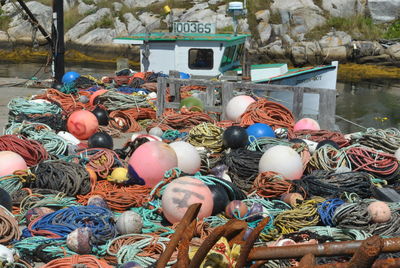 High angle view of fishing net and buoy on pier