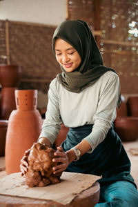 Woman working in potter workshop