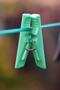 Close-up of clothespins hanging on rope