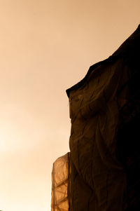 Low angle view of silhouette rock against sky during sunset