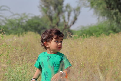 Girl looking away on field