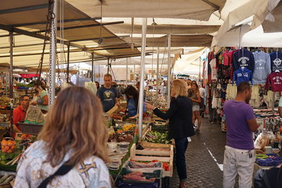 Group of people at market stall