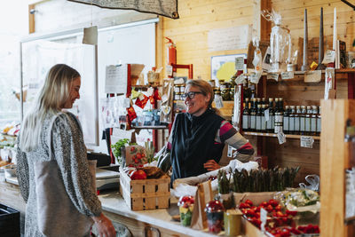 Client talking to shop assistant in shop