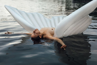 Young woman lying in swimming pool