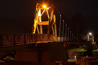 Illuminated suspension bridge at night