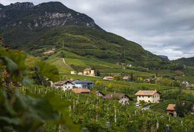 Scenic view of houses and mountains against sky