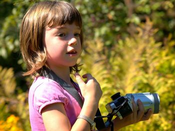 Portrait of cute girl photographing