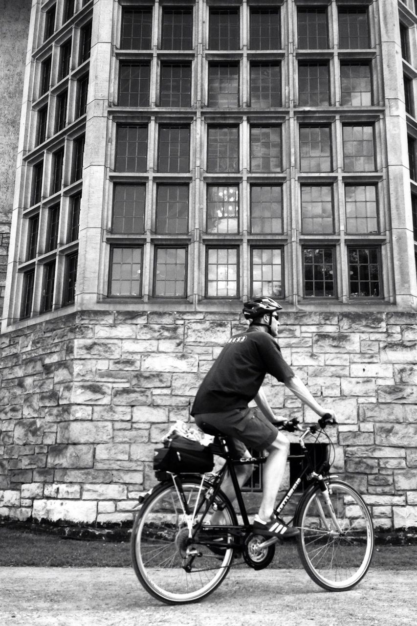 bicycle, building exterior, architecture, mode of transport, transportation, land vehicle, built structure, riding, men, lifestyles, leisure activity, side view, full length, city, street, stationary, building, travel