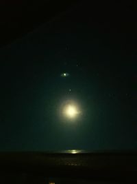 Low angle view of moon against sky at night