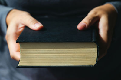 Close-up of hand holding book