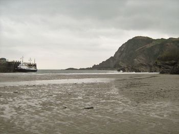 Scenic view of sea against cloudy sky