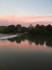 Scenic view of lake against sky at sunset