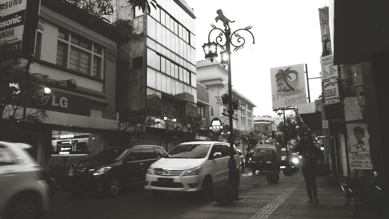 building exterior, car, street, architecture, city, transportation, land vehicle, built structure, mode of transport, city life, city street, road, incidental people, traffic, building, on the move, walking, men, the way forward