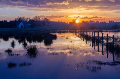 Scenic view of lake at sunset