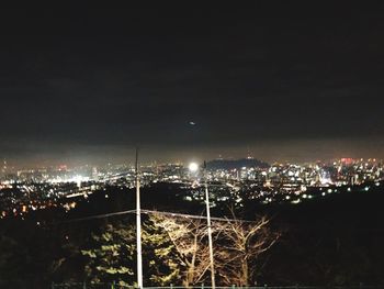 High angle view of illuminated buildings against sky at night