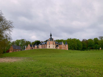 View of building on field against cloudy sky