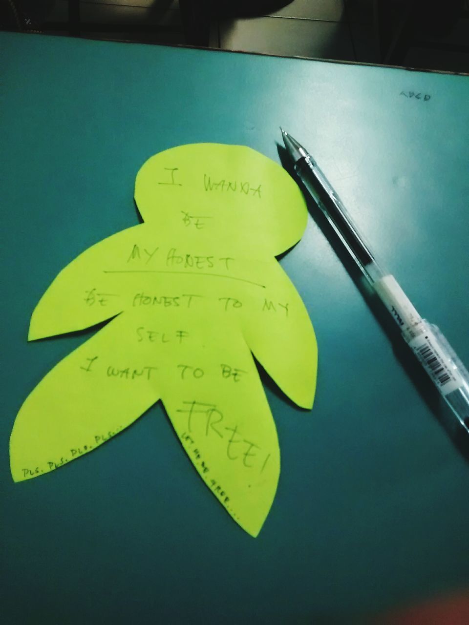 text, western script, communication, yellow, paper, close-up, still life, indoors, high angle view, no people, single object, table, education, blue, handwriting, capital letter, book, message, pencil, creativity