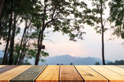 Wooden board empty table in front of blurred background. perspective brown wood over blur 