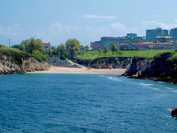 Scenic view of sea against sky in city