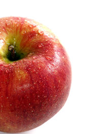 Close-up of red apple over white background