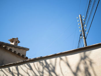 Low angle view of horse against clear blue sky