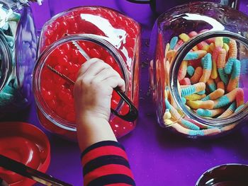 Close-up of hand holding multi colored candies