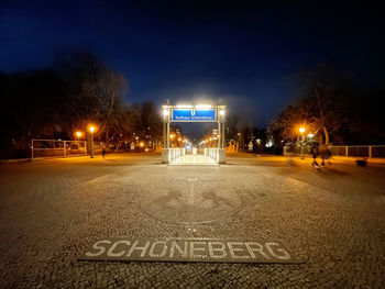 View of road sign at night