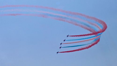 Low angle view of airplane flying against sky