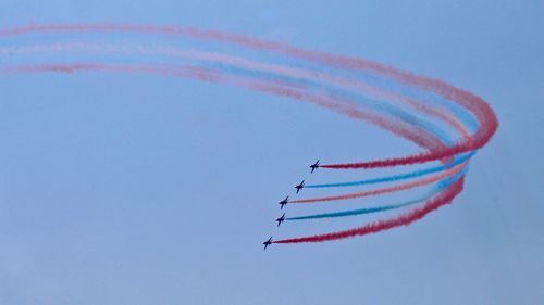Low angle view of airplane flying against sky