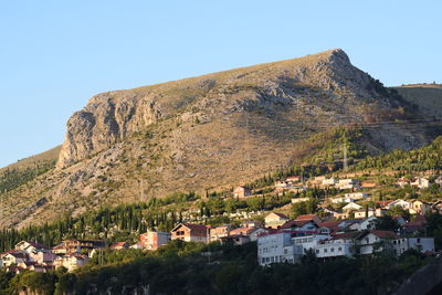 Buildings in town against clear sky