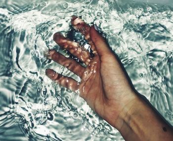 Close-up of person hand holding water