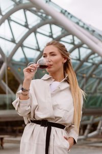 Young woman drinking wine in the park