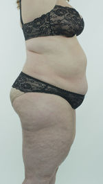 Close-up of young woman standing against white background