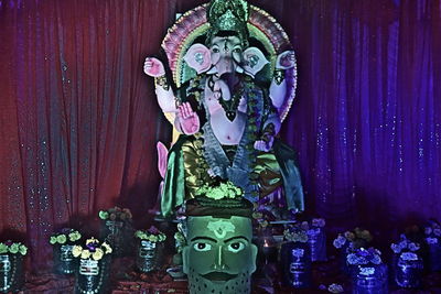 Close-up of buddha statue against wall