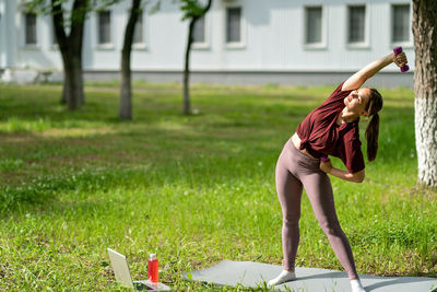 Full length of woman exercising in park