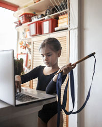 Woman using phone while sitting on table