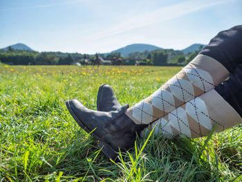 Woman horse rider sit with crossed legs in horse paddock boots and long tights. horse farm and sport