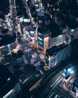 High angle view of illuminated city street and buildings at night