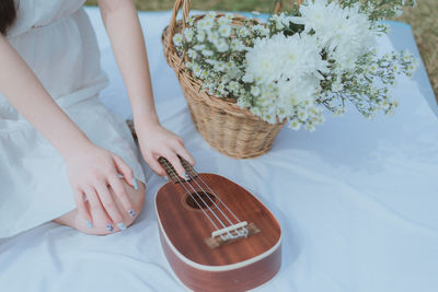 Midsection of woman playing guitar