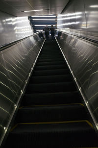 Low angle view of people on escalator