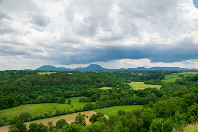 View of the chain of auvergne volcanoes under a thunderstorm