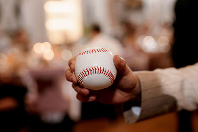 Close-up of hand holding baseball