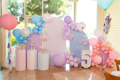 Multi colored balloons on table at home