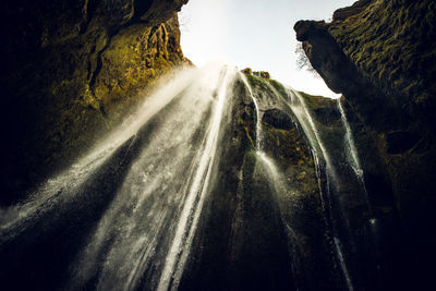 Low angel view of waterfall against sky